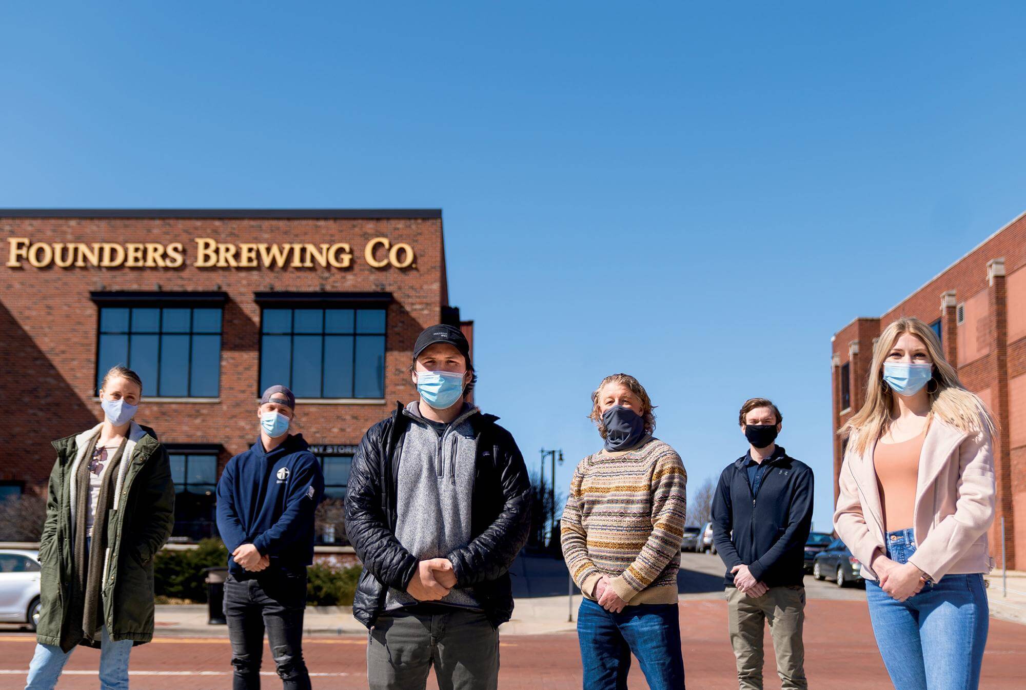 Darien Ripple, third from right, stands in front of Founder Brewing Co. with several students who collaborated to create a beer for the brewery. Liz Wonder &#8217;13, Founders' sustainability coordinator, is at the far left.